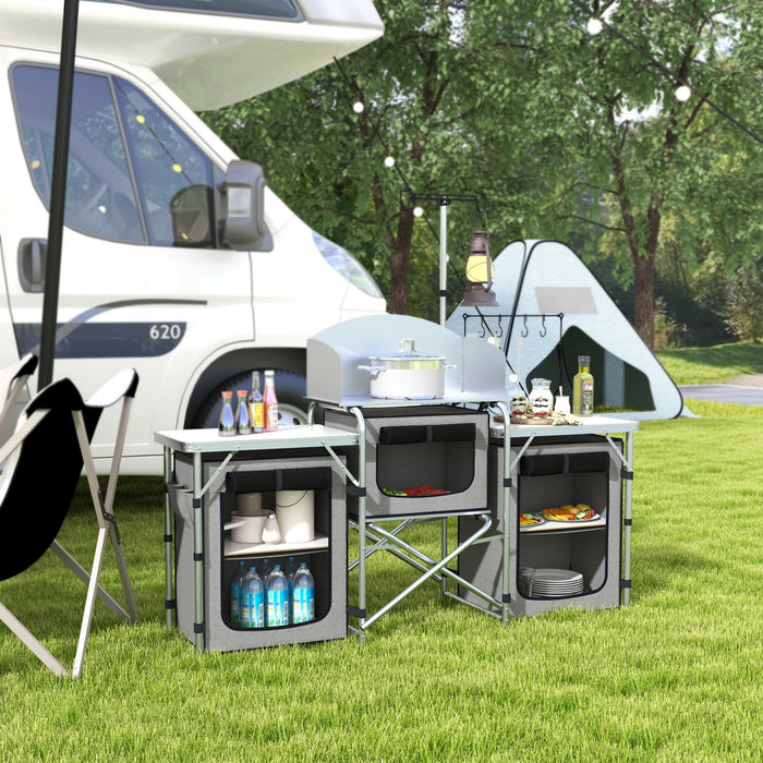 Outsunny Folding Camping Kitchen Table with Storage, Aluminum Portable Camping Table with 3 Fabric Cupboards, Windshield, Light Stand, Carrying Bag for BBQ, RV, Picnic, Grey